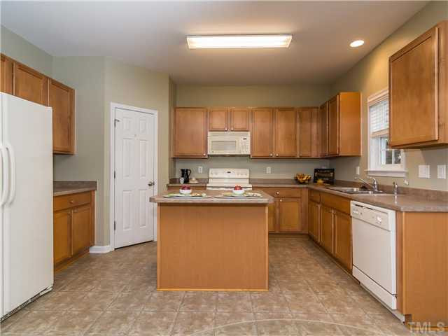 108 Hardaway Point Clayton, NC 27527 - Photo 7 of 21 a large kitchen with stainless steel appliances granite countertop a stove a sink dishwasher and a refrigerator
