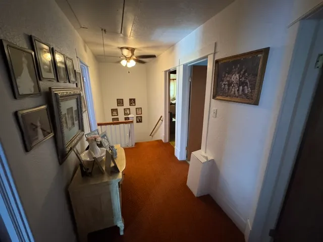 a view of a hallway with furniture and a livingroom