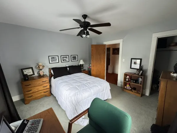 a bedroom with a bed and a chandelier