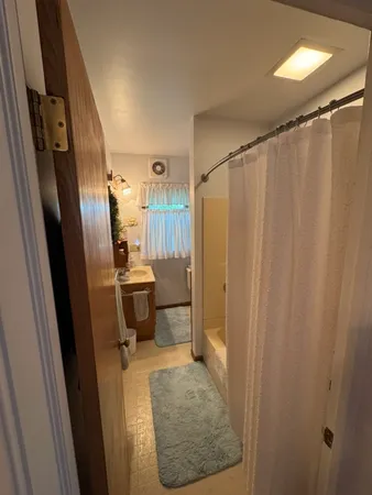 a bathroom with a sink a toilet a shower and a mirror