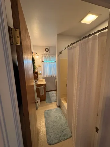 a bathroom with a sink a toilet a shower and a mirror