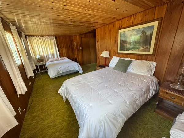 a bedroom with double bed and a window