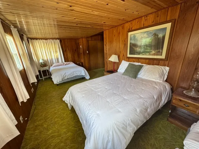 a bedroom with double bed and a window