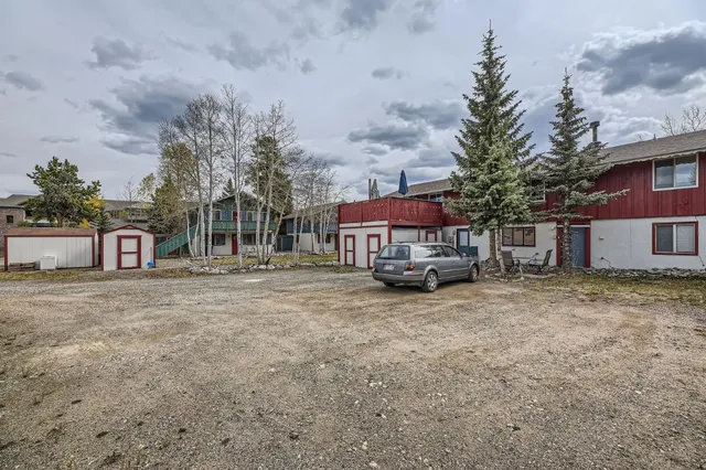 a car parked in front of a brick house