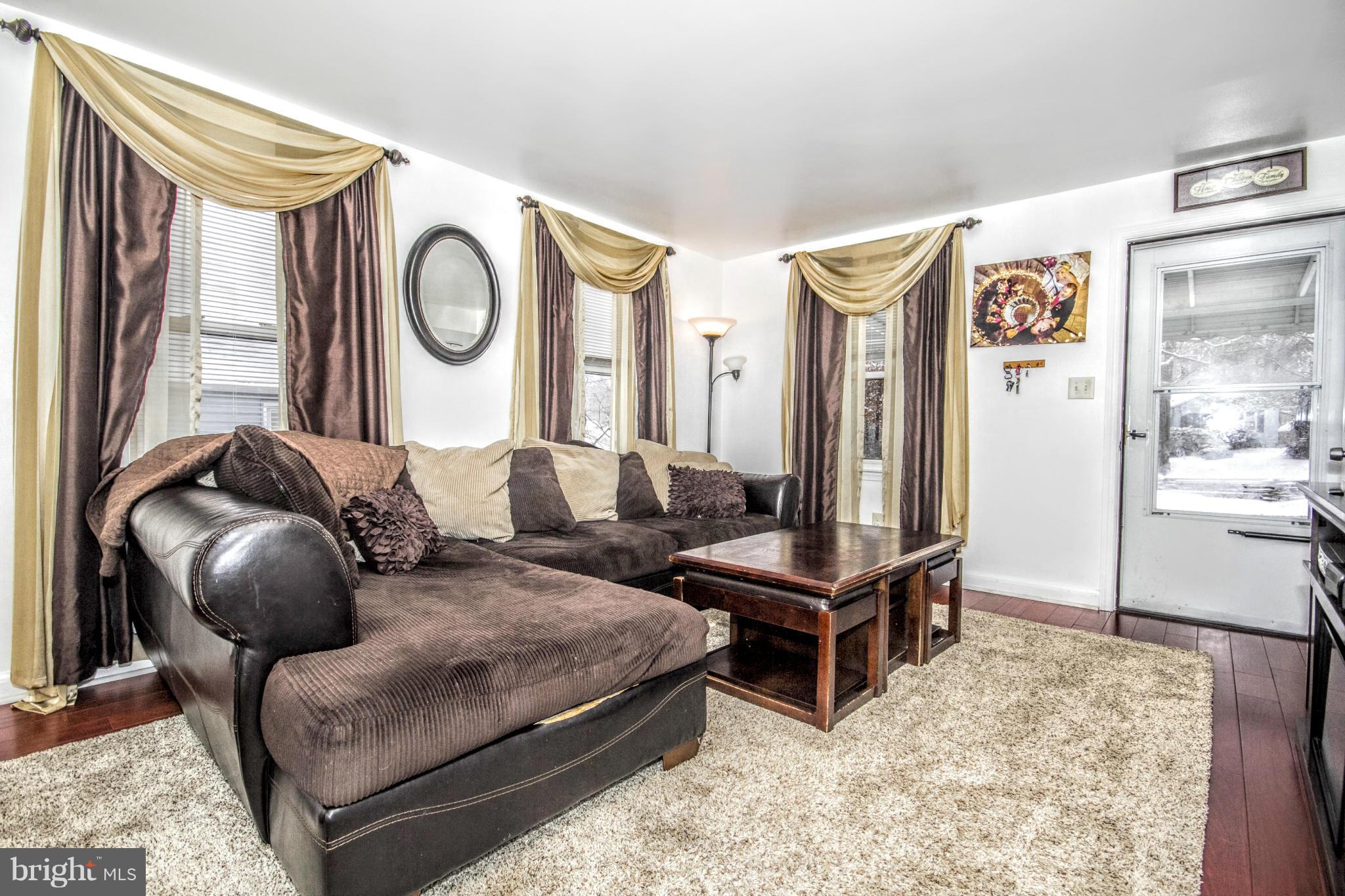 8109 Conduit Road Baltimore, MD 21234 - Photo 1 of 26 a living room with furniture and a mirror