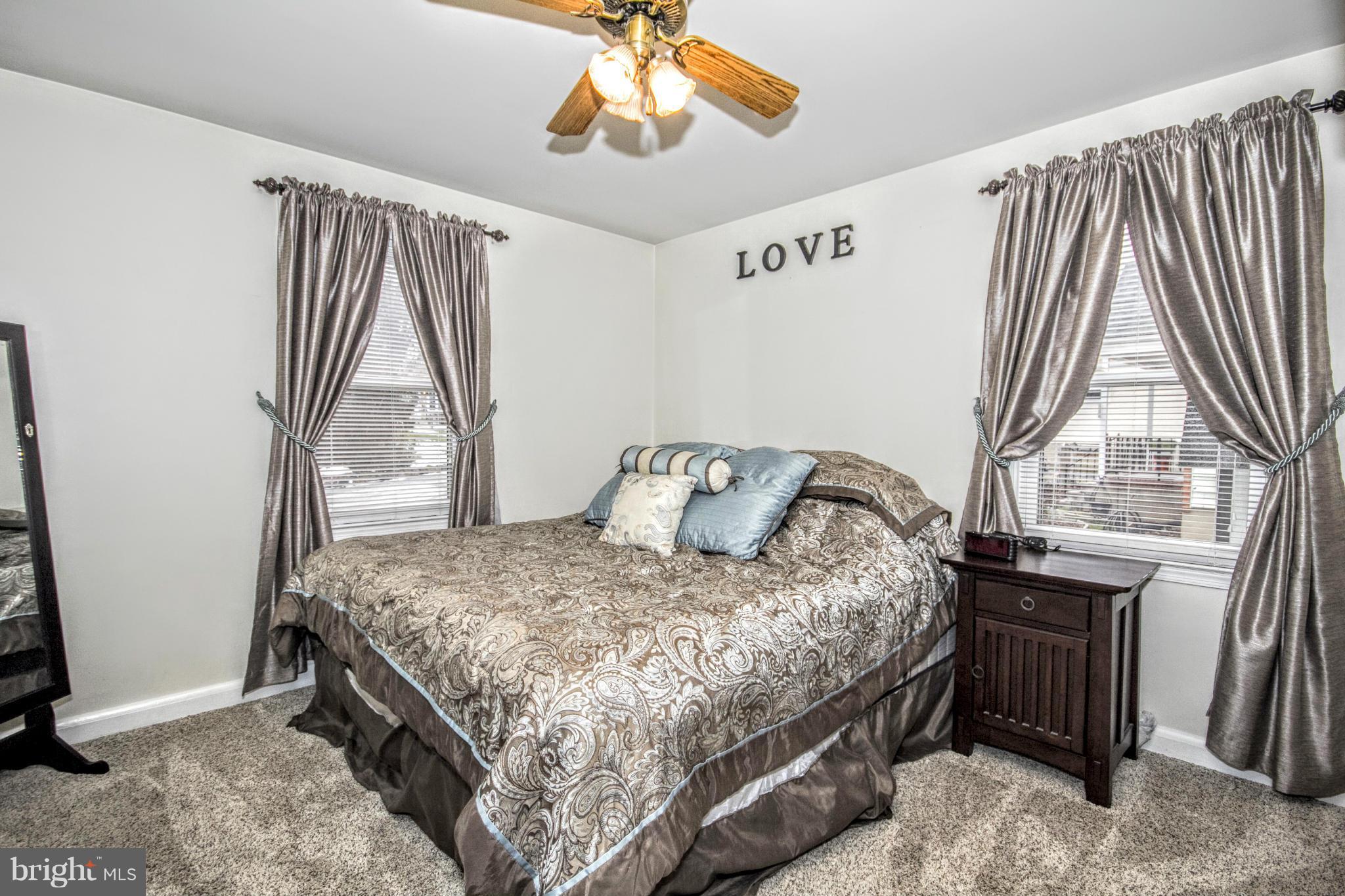 8109 Conduit Road Baltimore, MD 21234 - Photo 3 of 26 a bedroom with a bed and a window