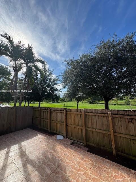 7250 Northwest 174th Terrace, Unit 102 Hialeah, FL 33015 - Photo 18 of 37 a view of a backyard with wooden fence