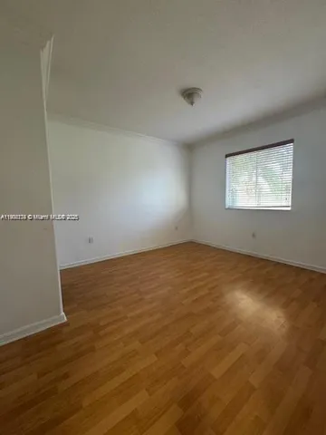 an empty room with a empty space and windows