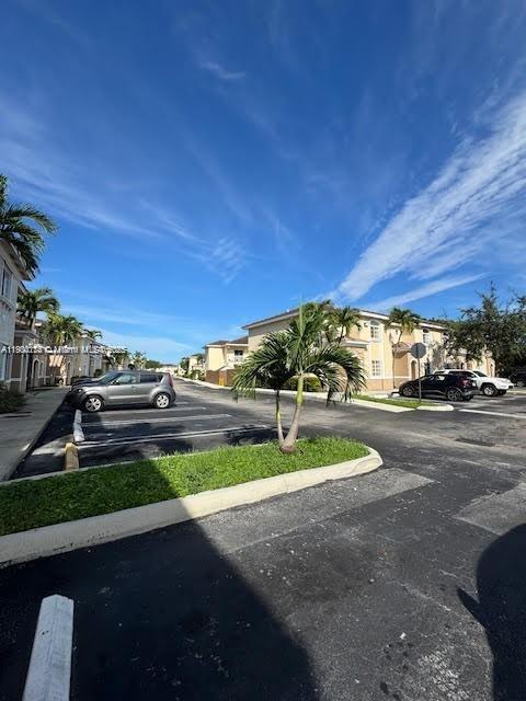 7250 Northwest 174th Terrace, Unit 102 Hialeah, FL 33015 - Photo 35 of 37 a view of a street with cars parked