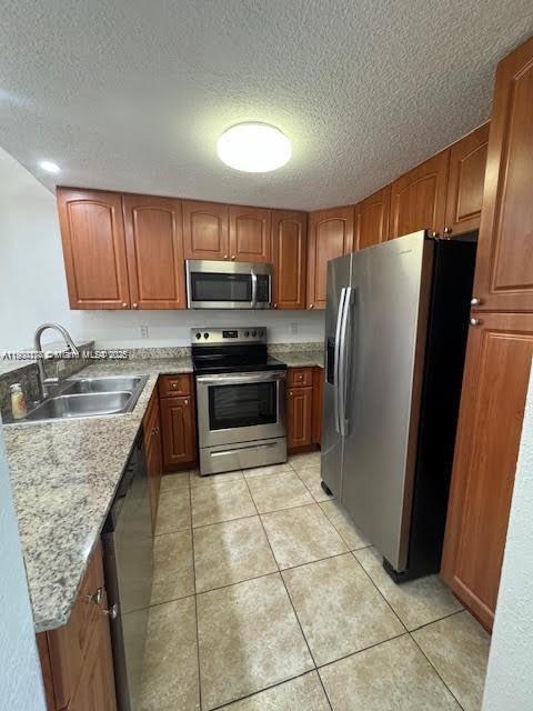 7250 Northwest 174th Terrace, Unit 102 Hialeah, FL 33015 - Photo 9 of 37 a kitchen with granite countertop a refrigerator a stove a sink a microwave and island