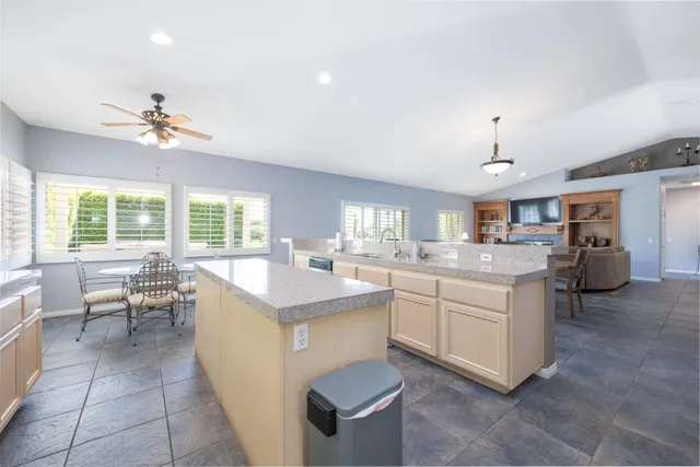a kitchen with sink cabinets and living room view