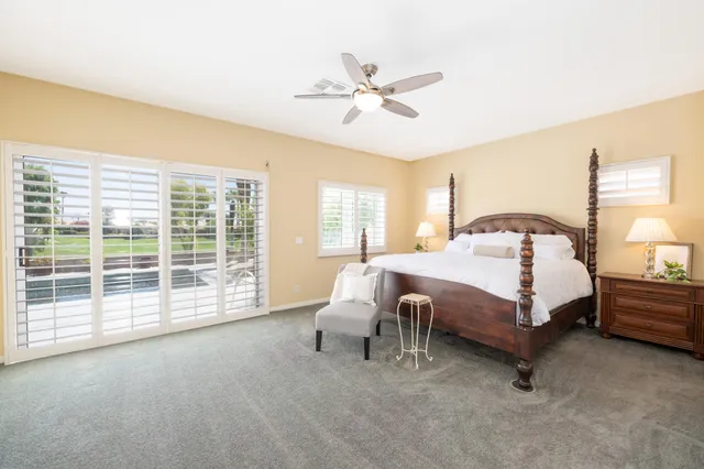 a bed room with a bed and a chair