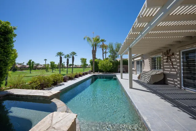 a view of a house with a yard and furniture