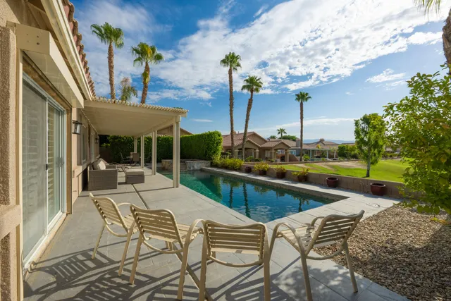 a view of swimming pool with outdoor seating