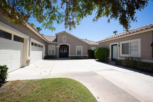 a large white house with a large tree