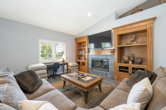 a living room with furniture fireplace and window