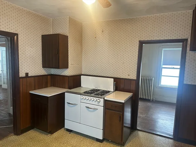 a kitchen with stainless steel appliances a refrigerator and a stove