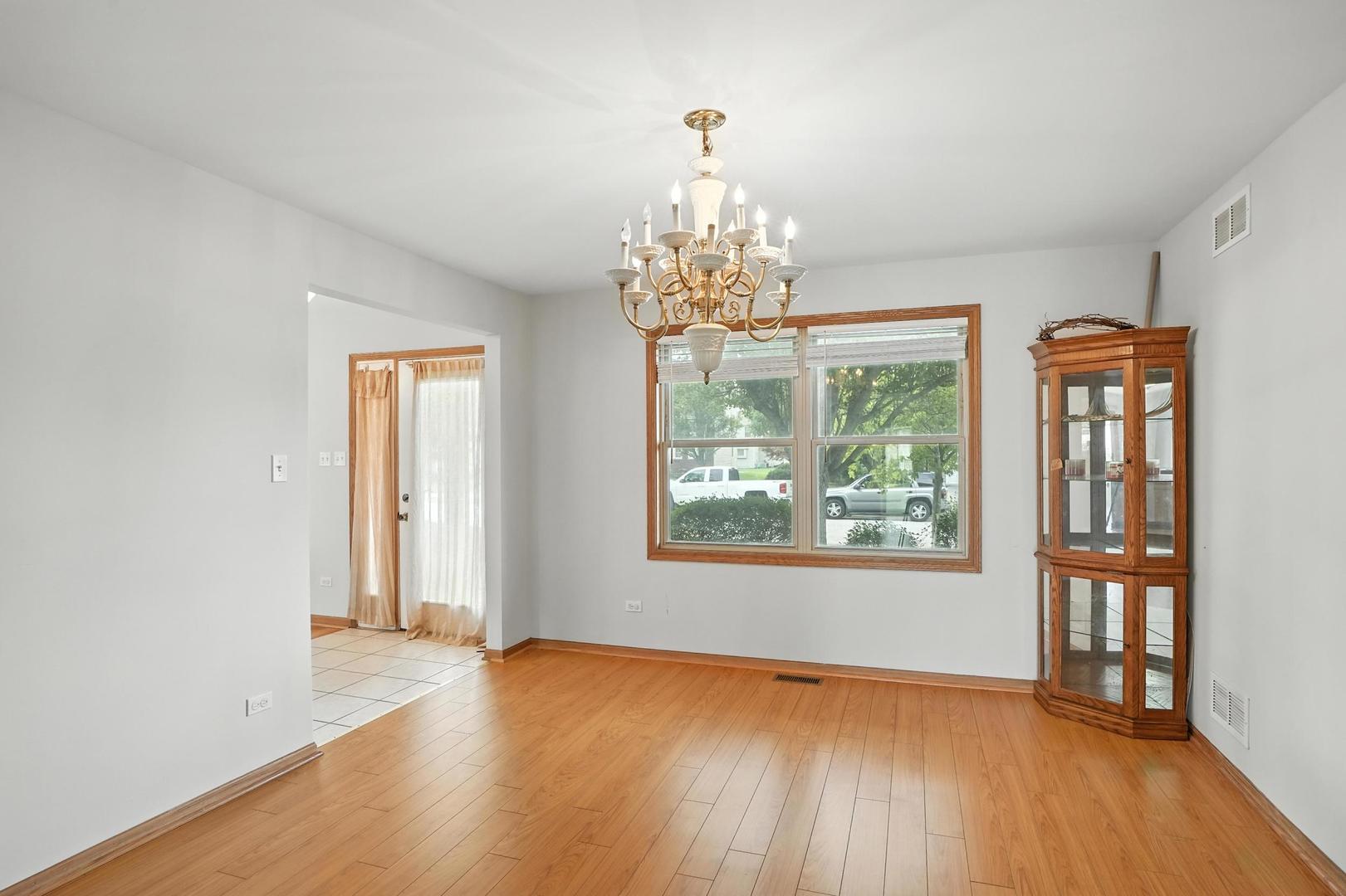 1665 Fox Hound Trail Beecher, IL 60401 - Photo 12 of 34 a view of an empty room with wooden floor and a window