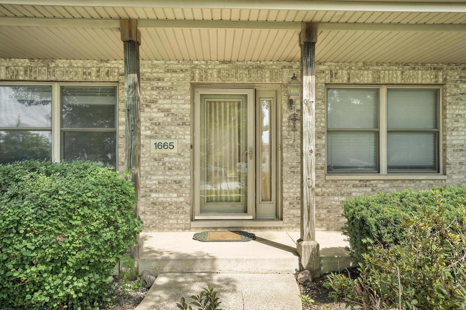 1665 Fox Hound Trail Beecher, IL 60401 - Photo 2 of 34 front view of a brick house with a large window and door