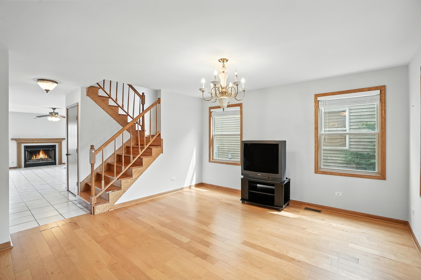 1665 Fox Hound Trail Beecher, IL 60401 - Photo 8 of 34 a view of a livingroom with wooden floor and a flat screen tv
