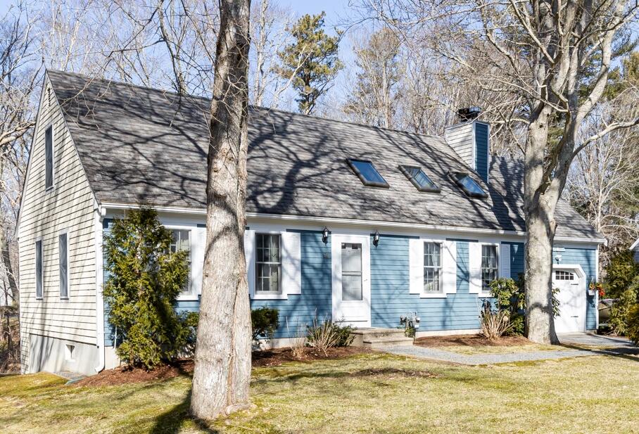 a view of a brick house with a large windows and a tree