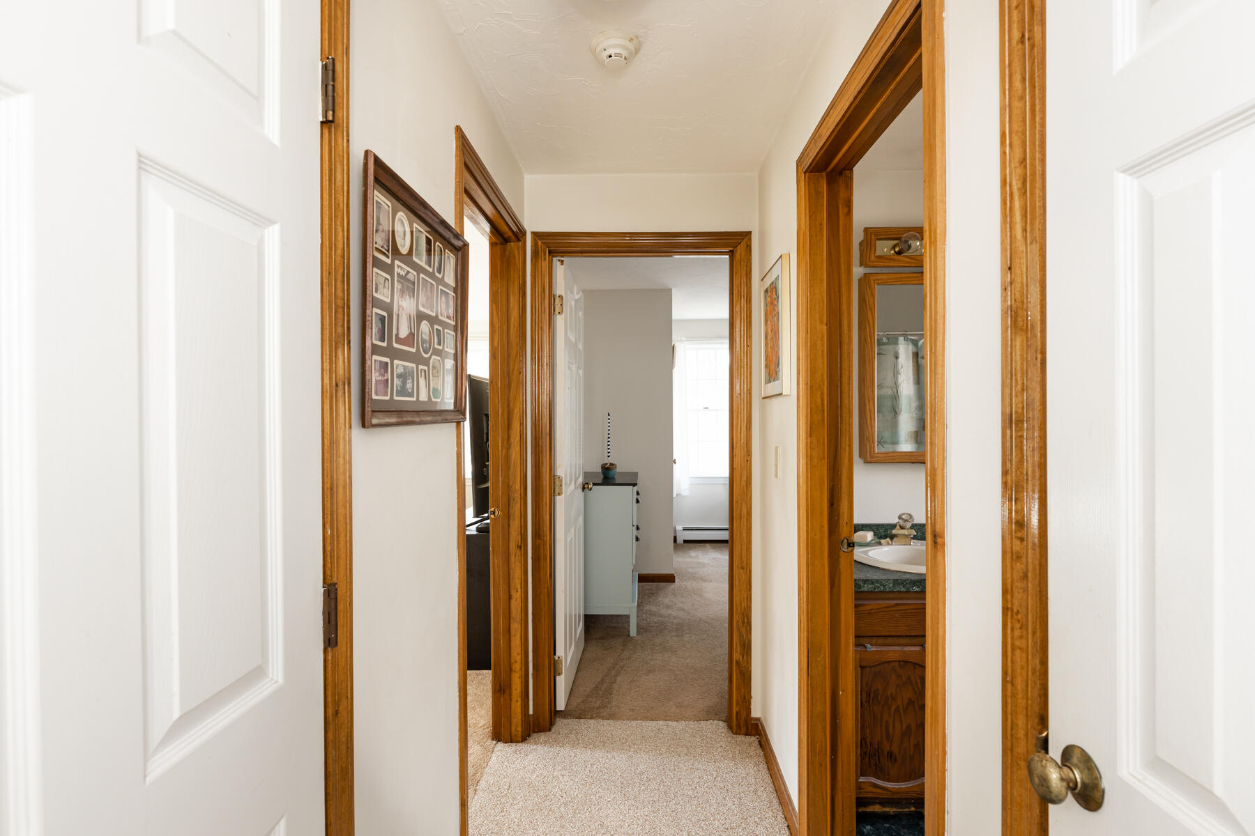 61 Edgewater Road Mashpee, MA 02649 - Photo 16 of 45 a view of a hallway with a livingroom and a bathroom