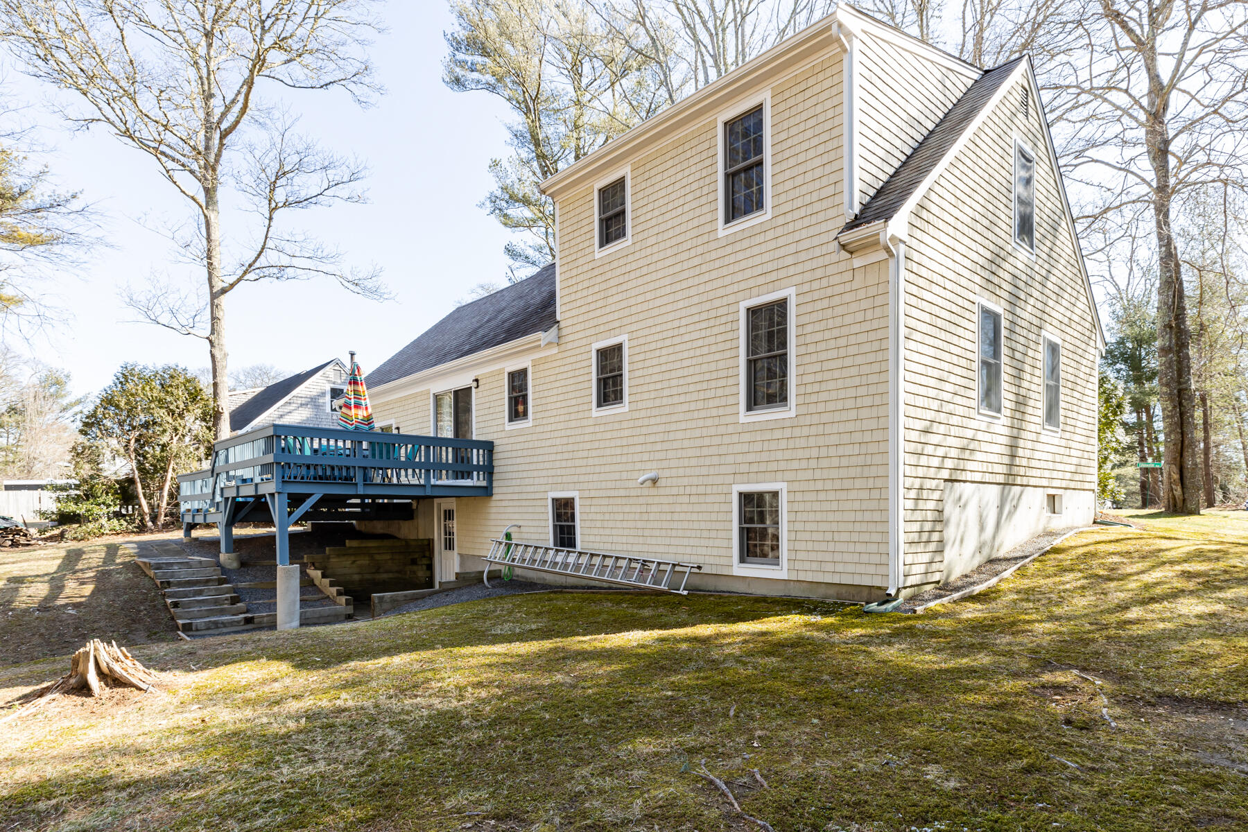 61 Edgewater Road Mashpee, MA 02649 - Photo 33 of 45 a view of a house with a yard chairs and floor to ceiling window