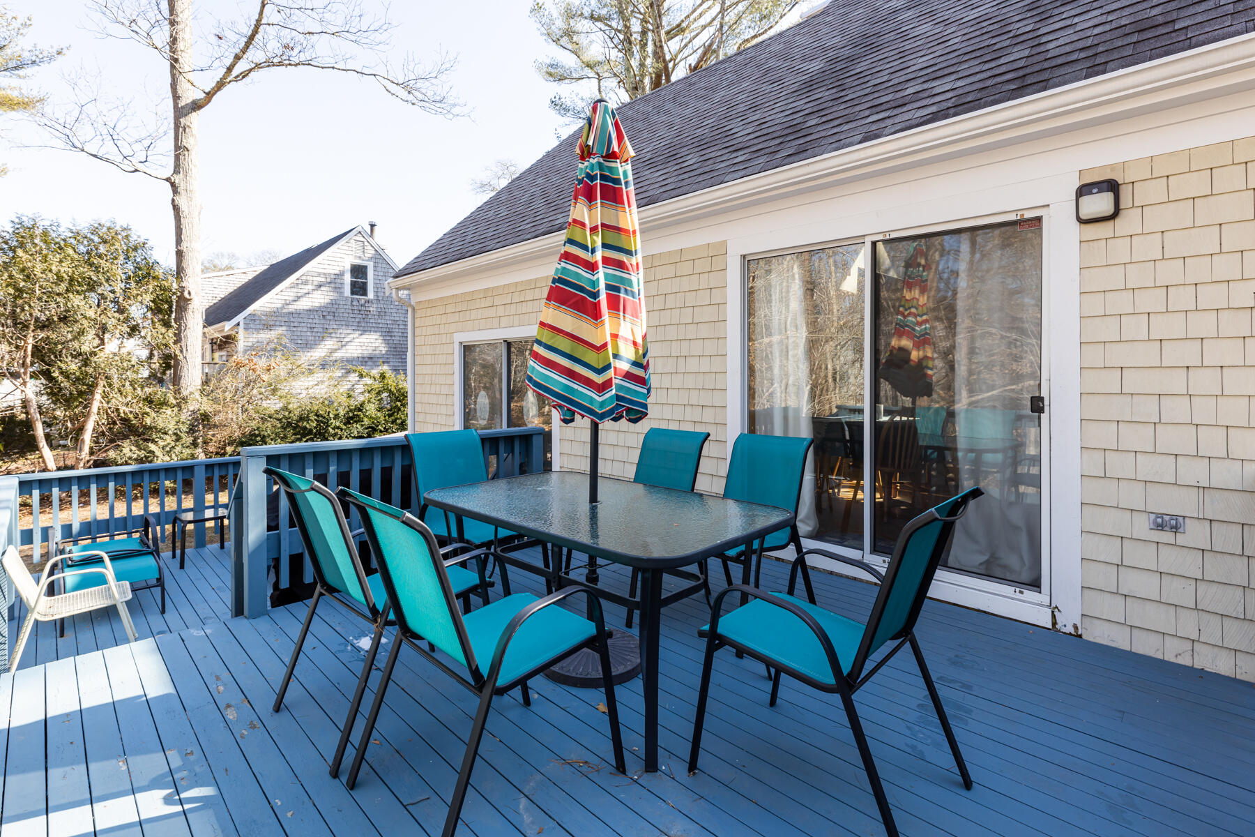 61 Edgewater Road Mashpee, MA 02649 - Photo 36 of 45 a balcony with wooden floor table and chairs