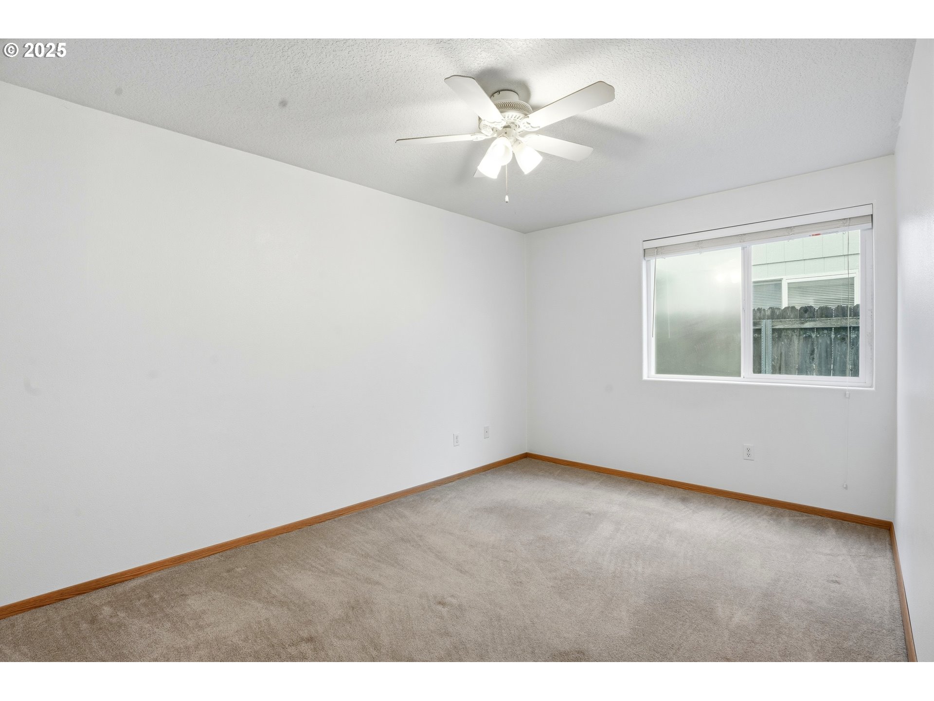 513 Southeast Clark Avenue Battle Ground, WA 98604 - Photo 21 of 30 an empty room with wooden floor and fan