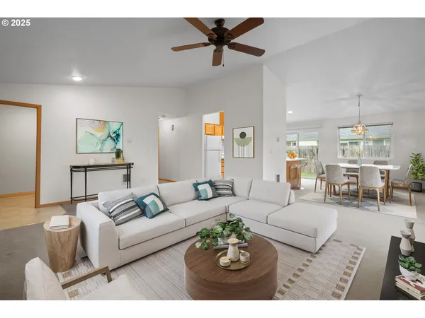 a living room with furniture a rug and a chandelier