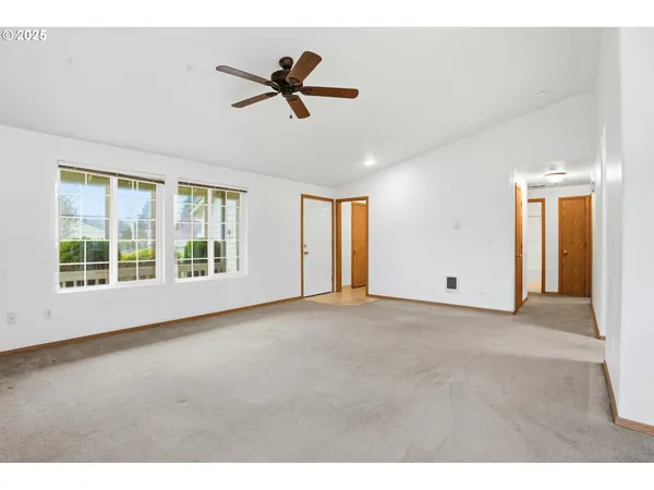 a view of a livingroom with a ceiling fan and window