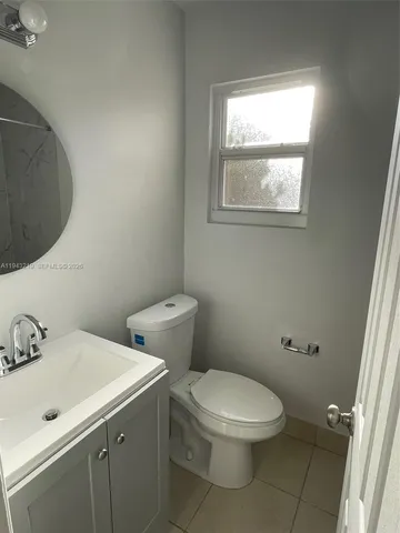 a white toilet sitting next to a bathroom sink