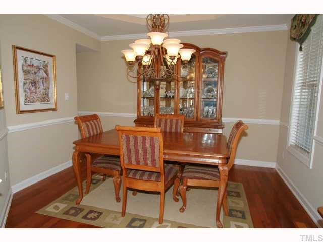 9227 Stone Mountain Road Raleigh, NC 27613 - Photo 3 of 12 a view of a dining room with furniture and wooden floor