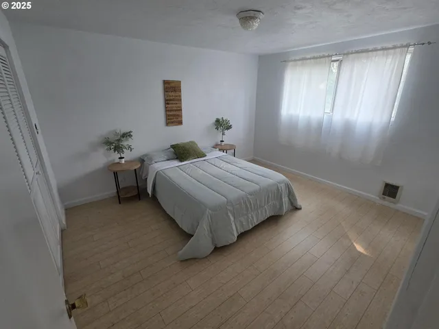 a bedroom with a bed and window