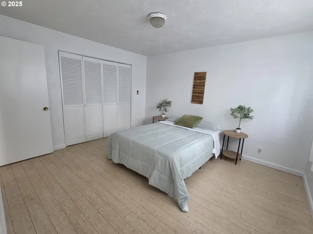 a bedroom with a bed and a table