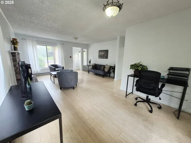 a view of a livingroom with workspace and a couch