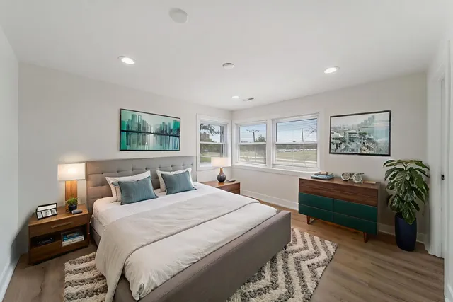 a bedroom with a bed and a chandelier