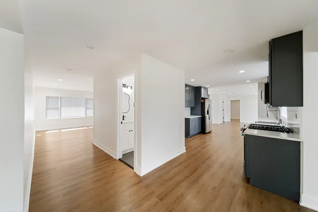 a view of a kitchen with wooden floor and a sink
