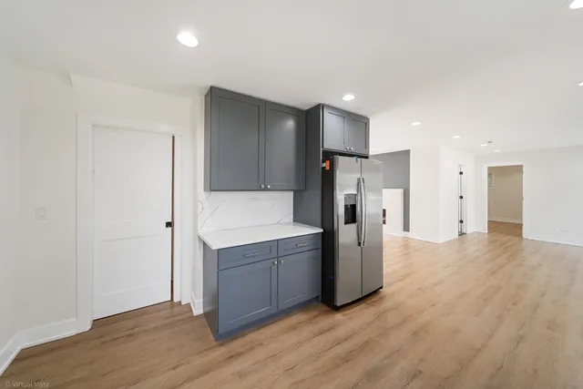 a view of a kitchen with a sink and a refrigerator