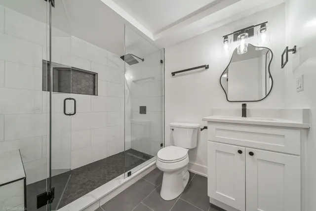 a bathroom with a toilet sink and shower