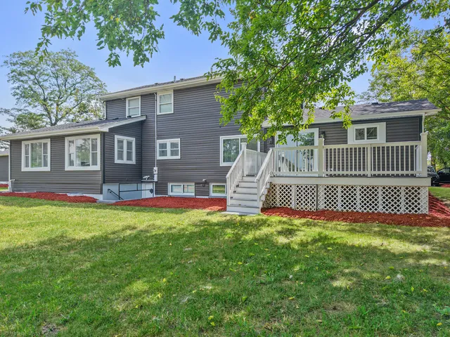 a front view of a house with a garden and deck