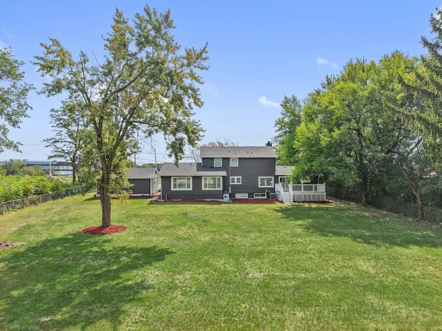 a house with a big yard and large trees