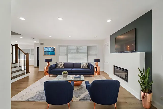 a living room with fireplace furniture and a flat screen tv