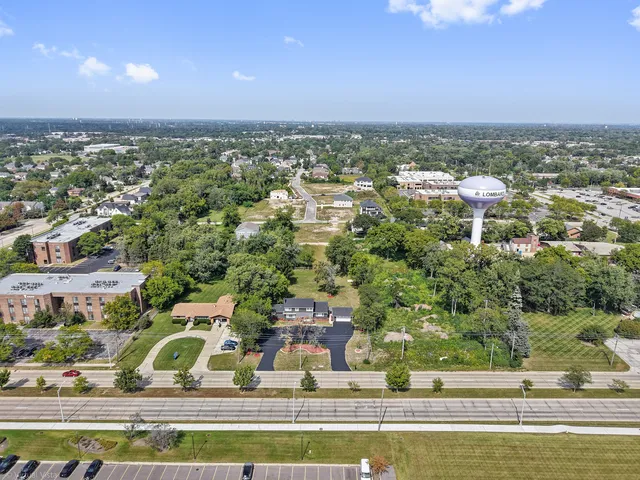 an aerial view of a house with a yard