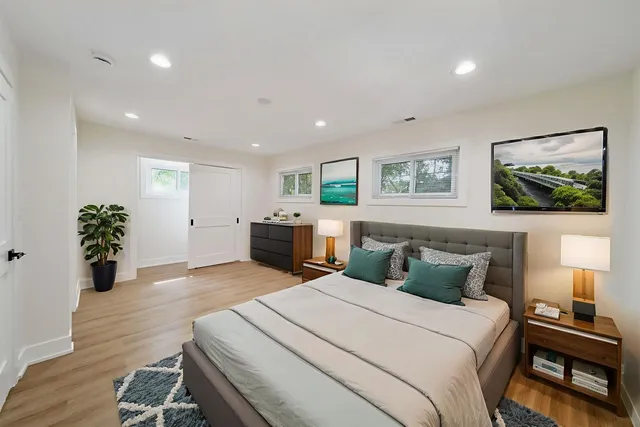 a bedroom with a bed and a potted plant