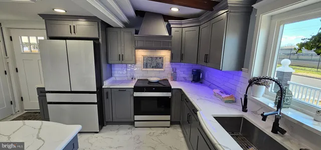 a kitchen with stainless steel appliances kitchen island granite countertop a refrigerator and a stove