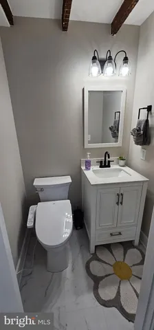 a bathroom with a toilet sink and mirror