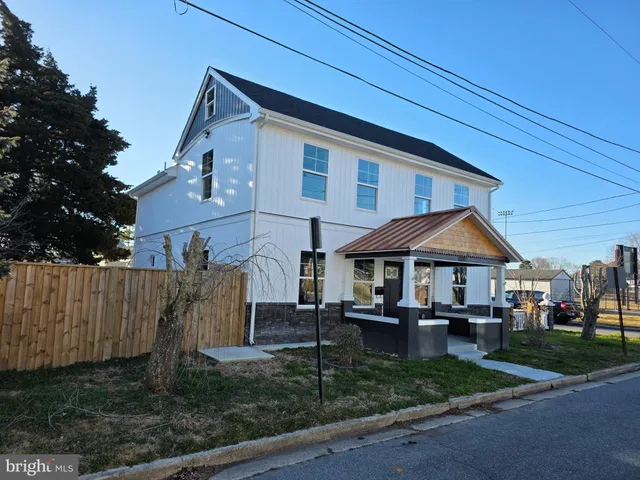 a patio with a table and chairs under an umbrella