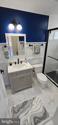 a room with a washing machine with the view of living room