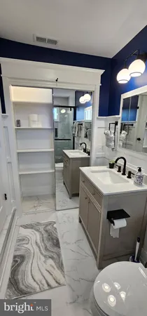 a bathroom with a sink a mirror and a shower